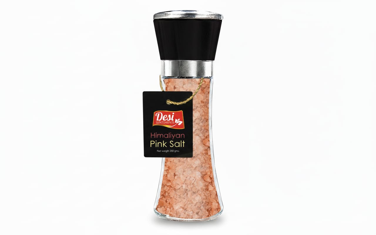 Bottle of Himalayan pink salt with a black cap on a white background