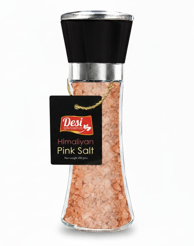 Bottle of Himalayan pink salt with a black cap on a white background